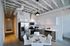 Sleek modern kitchen with stainless steel appliances, chic pendant lighting, and a stylish dining area.