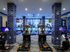 Modern fitness center with state-of-the-art treadmills, vibrant blue accents, and a pool view, perfect for an energizing workout.