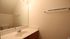 Bright, modern bathroom with sleek sink, large mirror, and elegant lighting.