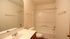 Bright and spacious bathroom with modern sink, elegant mirror, and pristine bathtub.