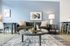 Chic living room with modern decor, featuring a comfortable sofa, stylish artwork, and a cozy ambiance enhanced by elegant lighting.