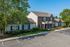 Charming apartment complex with classic brick facade, well-kept landscaping, and spacious parking area, nestled in a tranquil, tree-lined setting.