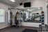 Modern fitness center with state-of-the-art exercise equipment, free weights, and large mirrors for an optimal workout experience.