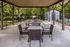 Inviting outdoor pavilion with stylish seating and lush green surroundings, perfect for gatherings and relaxation.