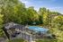 Inviting outdoor pool surrounded by lush greenery and cozy seating, ideal for relaxing in a serene setting.
