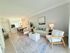 Bright and inviting living area with chic decor, cozy seating, and an open kitchen, perfect for modern living.