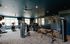 Modern fitness center equipped with state-of-the-art exercise machines and natural lighting, offering a vibrant and energetic workout space.