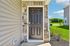Inviting entrance with a sleek black door surrounded by elegant stonework, leading to a welcoming home in a tranquil neighborhood.