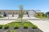 Charming suburban townhouse complex with beautiful landscaping and spacious driveways, ideal for modern family living.