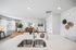 Bright and inviting open-concept living area with modern decor, featuring a comfortable seating space, elegant lighting, and contemporary wall art.
