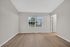 Bright, spacious room with elegant light wood flooring, large window offering scenic views, and neutral walls for a modern touch.