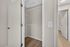 Bright, open closet space with modern shelving and sleek wooden floors, ideal for organized storage.