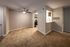 Inviting Ripple apartment with plush carpet living area and a modern kitchen pass-through, perfect for comfortable living.