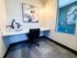 Modern workspace nook with elegant artwork, stylish lighting, and cozy furniture in the spacious clubhouse.