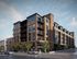 John Purdue Block with sleek architectural design, featuring large windows and spacious balconies, set in a vibrant city environment.