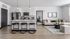 Modern open-concept apartment showcasing a sleek kitchen with an island, adjacent to a stylish living room with plush seating and elegant decor.