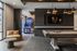 Chic recreation room with sleek billiards table, stylish lounge chair, and vibrant arcade basketball game, perfect for entertainment and relaxation.