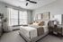 Inviting bedroom with abundant natural light filtered through stylish blinds.