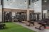 Modern fitness center with advanced workout equipment, vibrant atmosphere, and high ceilings, perfect for a dynamic exercise experience.