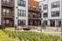 Modern apartment community showcasing a stylish courtyard with cozy seating and vibrant greenery.