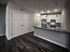 Modern kitchen with sleek countertops, stainless steel appliances, and elegant pendant lighting, perfect for culinary creativity.