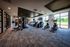 Bright and modern fitness center featuring state-of-the-art exercise equipment and floor-to-ceiling windows with a scenic view.