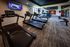 Modern fitness center with sleek treadmills, vibrant decor, and well-equipped exercise stations, offering a dynamic workout experience.