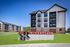 Modern apartment community featuring stylish architecture and lush green surroundings at Riverplace Flats.