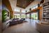 Spacious and elegant lounge area, featuring cozy sofas, large windows providing natural light, and contemporary lighting fixtures.