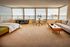 Spacious apartment with panoramic windows, featuring a cozy bedroom area, stylish seating that is flooded with natural light.