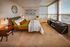 Bright and elegant bedroom with panoramic floor-to-ceiling windows, stylish decor, offering breathtaking city views.