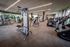 Modern gym with sleek fitness equipment, state-of-the-art machines, and a spacious, well-lit environment.