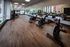 Modern fitness room with sleek exercise bikes, mirrored walls, and bright natural light, perfect for an invigorating workout.