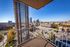 Breathtaking cityscape view from a balcony, showcasing vibrant downtown skyline.