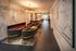 Luxurious lounge area with modern marble walls, chic fireplace, and elegant seating arrangement under stylish lighting.