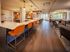 Contemporary lounge area featuring elegant bar seating, stylish lighting, and expansive windows with a scenic view.