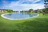 Serene apartment complex with a charming pond and fountain surrounded by lush greenery and modern buildings.