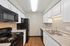 Modern kitchen with sleek black appliances, elegant white cabinetry, and luxurious granite countertops.