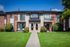 Charming apartment complex with vibrant garden views, private balconies, and cozy outdoor seating area.