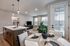 Modern open-concept apartment with elegant kitchen island, cozy living area, and chic dining space, filled with natural light.
