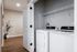 Modern laundry nook with sleek washer and dryer and stylish wood flooring.