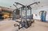 Modern fitness center with state-of-the-art exercise equipment, vibrant striped wall, and spacious workout area.