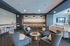 Elegant living space featuring plush gray seating, modern lighting, and a cozy entertainment area, perfect for relaxation and social gatherings.