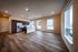 Bright modern apartment with open-concept layout, featuring elegant hardwood floors, a sleek kitchen with stainless steel appliances, and ample natural light from large windows.