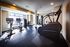 Modern apartment gym with state-of-the-art equipment, bright natural lighting, and sleek design for an invigorating workout experience.