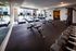 Modern fitness center with state-of-the-art treadmills, weight benches, and a variety of free weights.