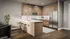 Modern kitchen with sleek wooden cabinetry, stylish pendant lighting, and a spacious island with bar seating at The Vault on Main.