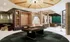 Luxurious modern lounge area at The Vault on Main with a sleek pool table, stylish seating, and elegant marble accents, perfect for entertainment and relaxation.