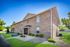 Charming brick apartment building with manicured landscaping and a welcoming entrance.