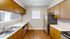 Inviting kitchen with wood cabinetry, modern appliances, and sleek countertops, perfect for culinary creativity.